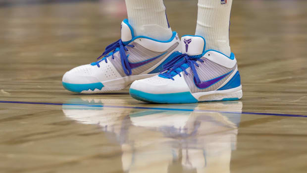 A view of white, teal, and purple Nike Kobe shoes.
